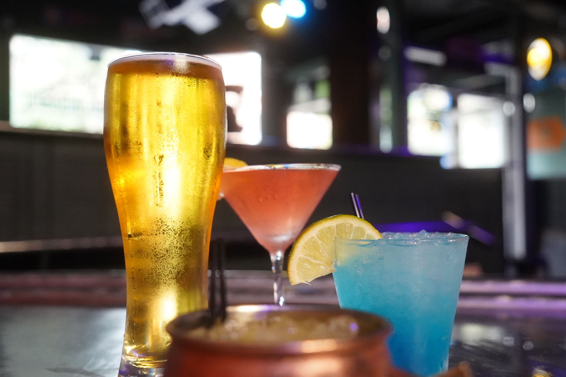 Cocktails staged on the bar with neon ambient lighting