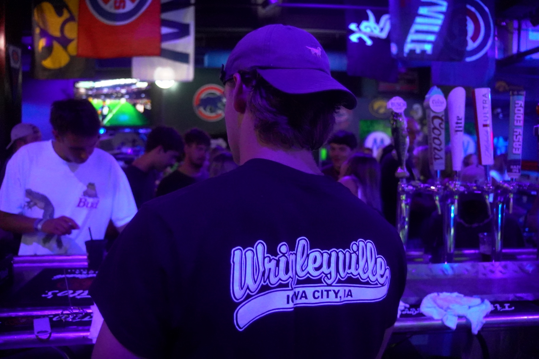 Wrigleyville Iowa City tee at the tap wall
