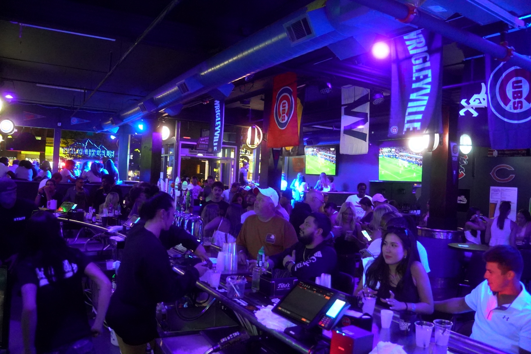 Packed bar on game day under Cubs flags and W banners