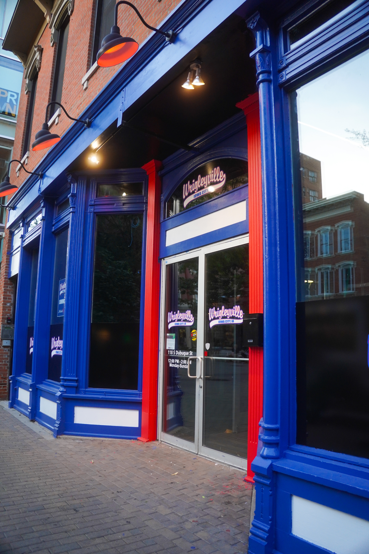 Gooseneck lights and blue facade outside Wrigleyville