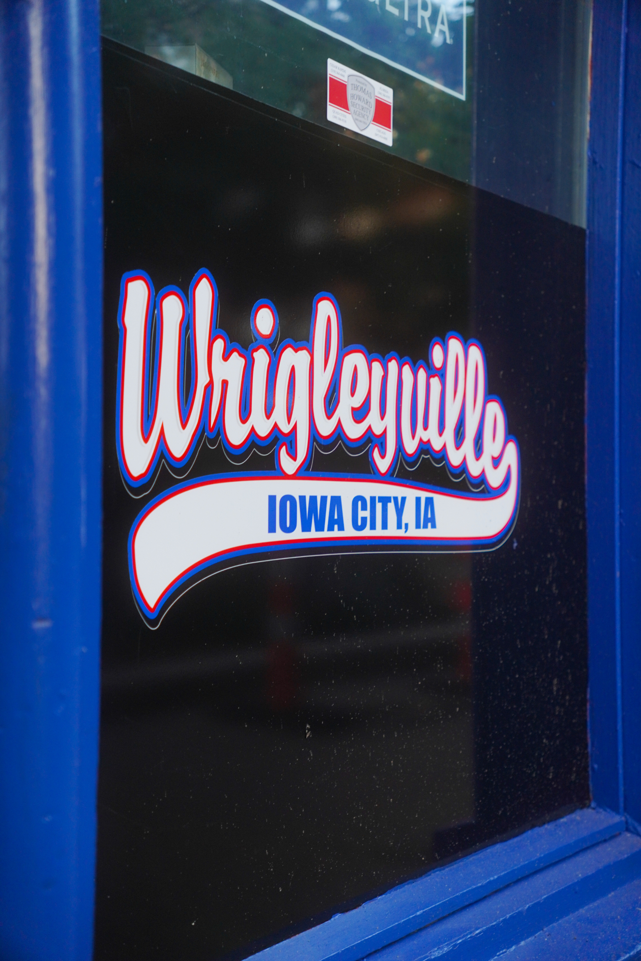 Wrigleyville Iowa City script logo on the front window